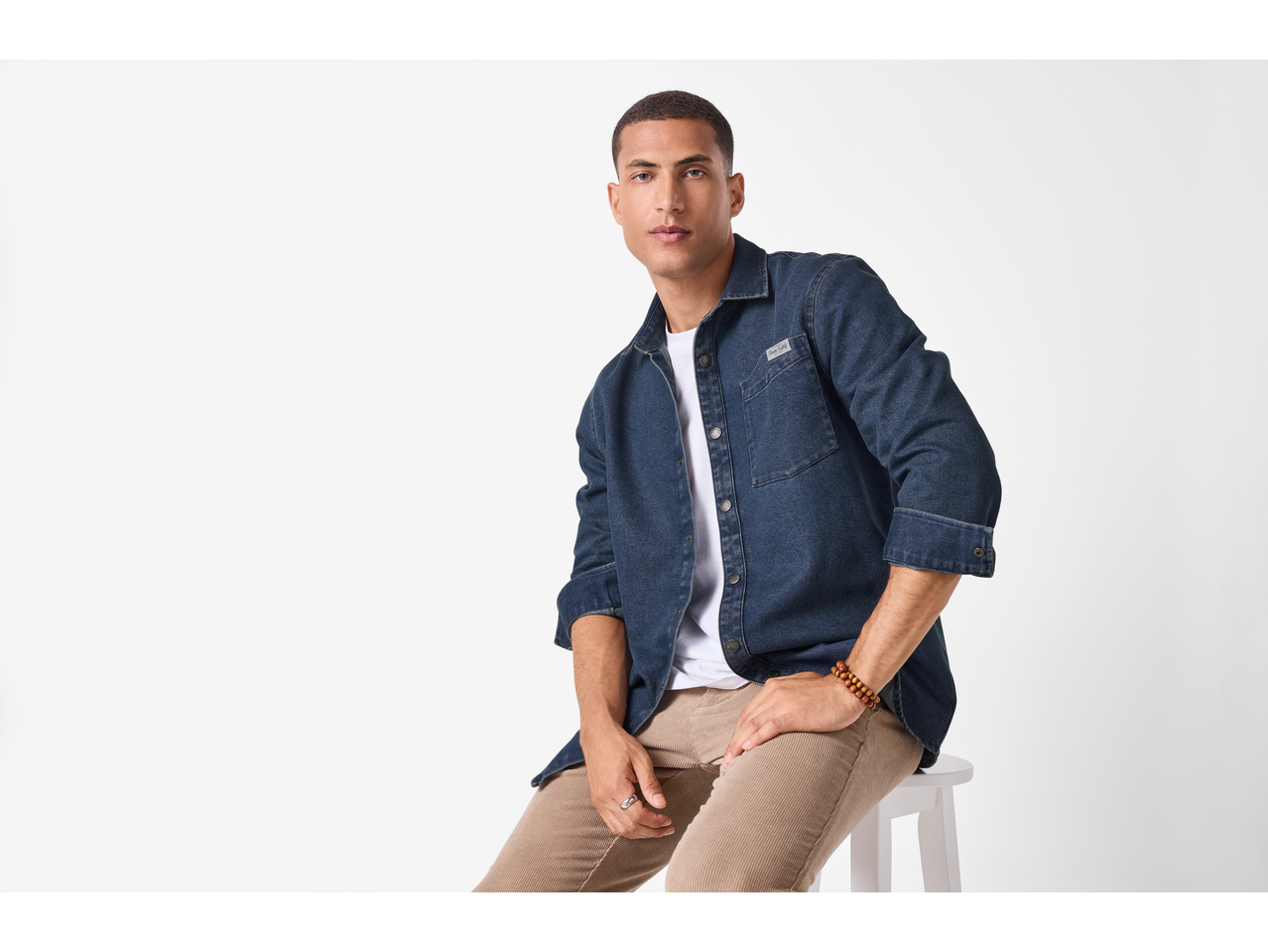 esmara® Men's Denim Shirt in dark blue, worn over a white t-shirt with beige trousers.