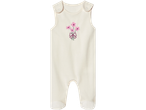 Kreemikas beebikombinesoon tikitud roosade lillede ja lipsuga.