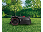 PARKSIDE PERFORMANCE® 20V Robot Lawn Mower on green grass with blurred trees in background.