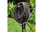 Parkside Performance® garden hose, 20 m, coiled on a stand in a garden.
