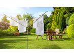 A rotary clothesline in a lush garden with white laundry drying in the sun.