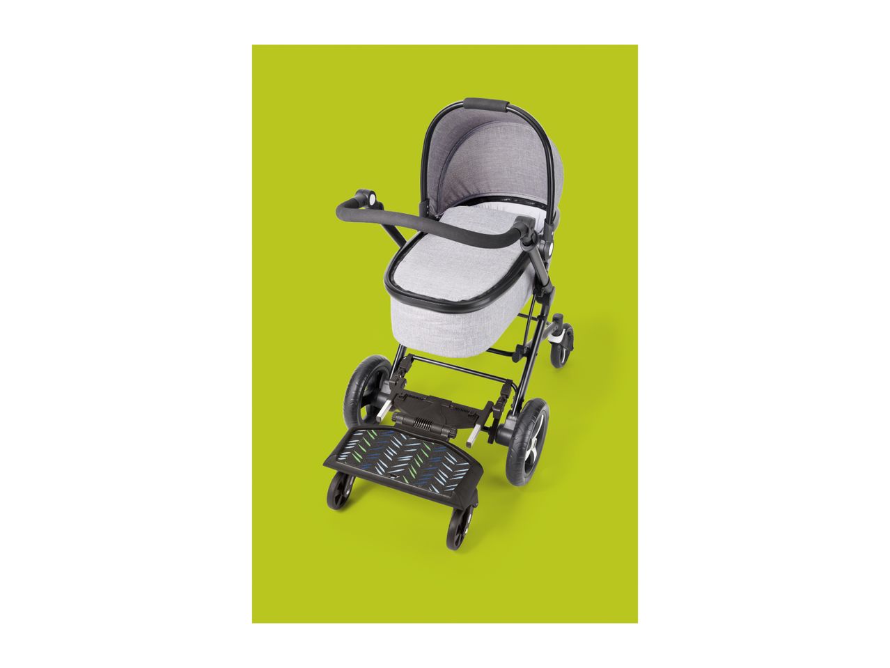 Grey baby stroller with a black ride-on board attached, on a green background.