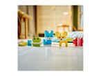 Colorful building blocks shaped as a green bird, blue cat, yellow dog, and red caterpillar.