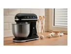 Black stand mixer with the number 1973 on a kitchen counter next to baking ingredients.