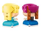 Two brick-built figures, one with yellow hair and one with magenta hair, standing side-by-side.