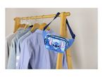 Blue fanny pack with a cartoon character and tropical leaves, hanging on a wooden clothes rack.
