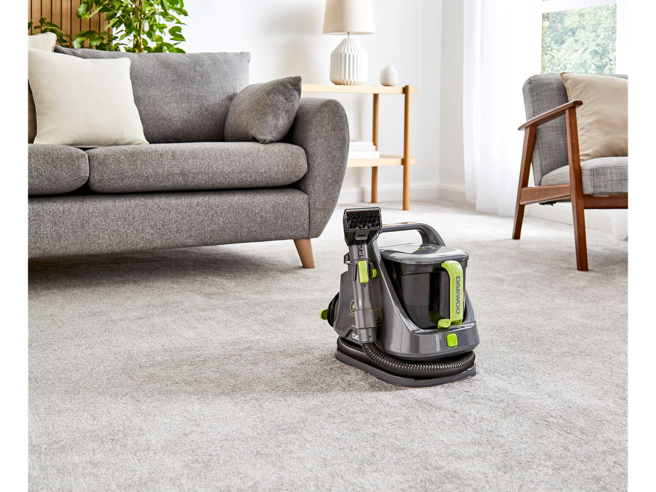 A Daewoo carpet cleaner sits on a light grey carpet in a living room.