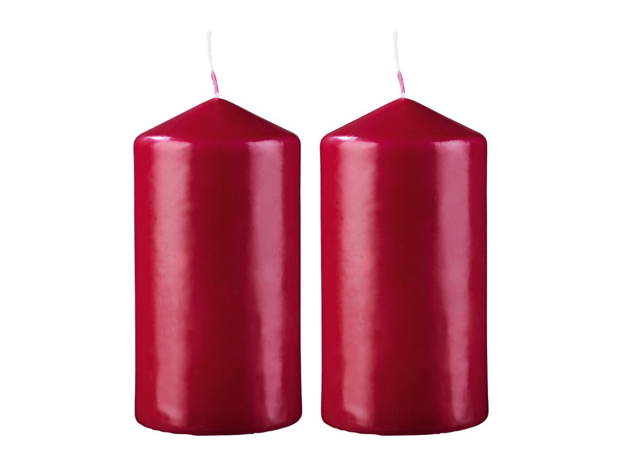 Two red pillar candles with wicks, isolated on a white background.