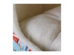 Close-up of a cozy pet bed with a soft, white faux fur interior and a playful city-themed exterior.