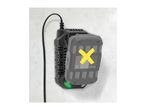 A Parkside battery charger mounted on a wall with a battery inserted, marked with a yellow X.