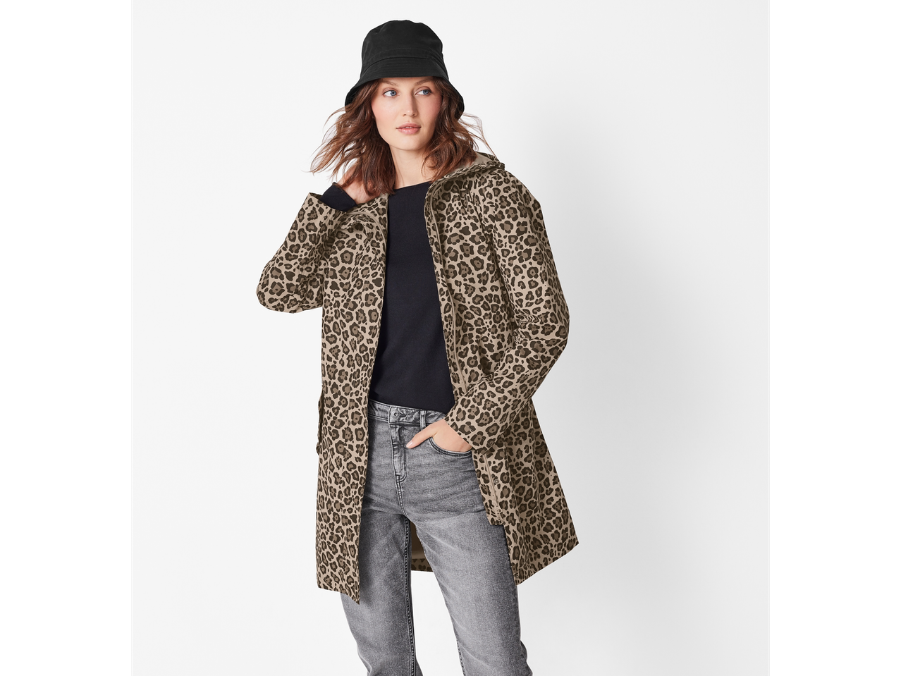 Woman in a leopard print jacket, black top, and gray jeans with a black bucket hat.