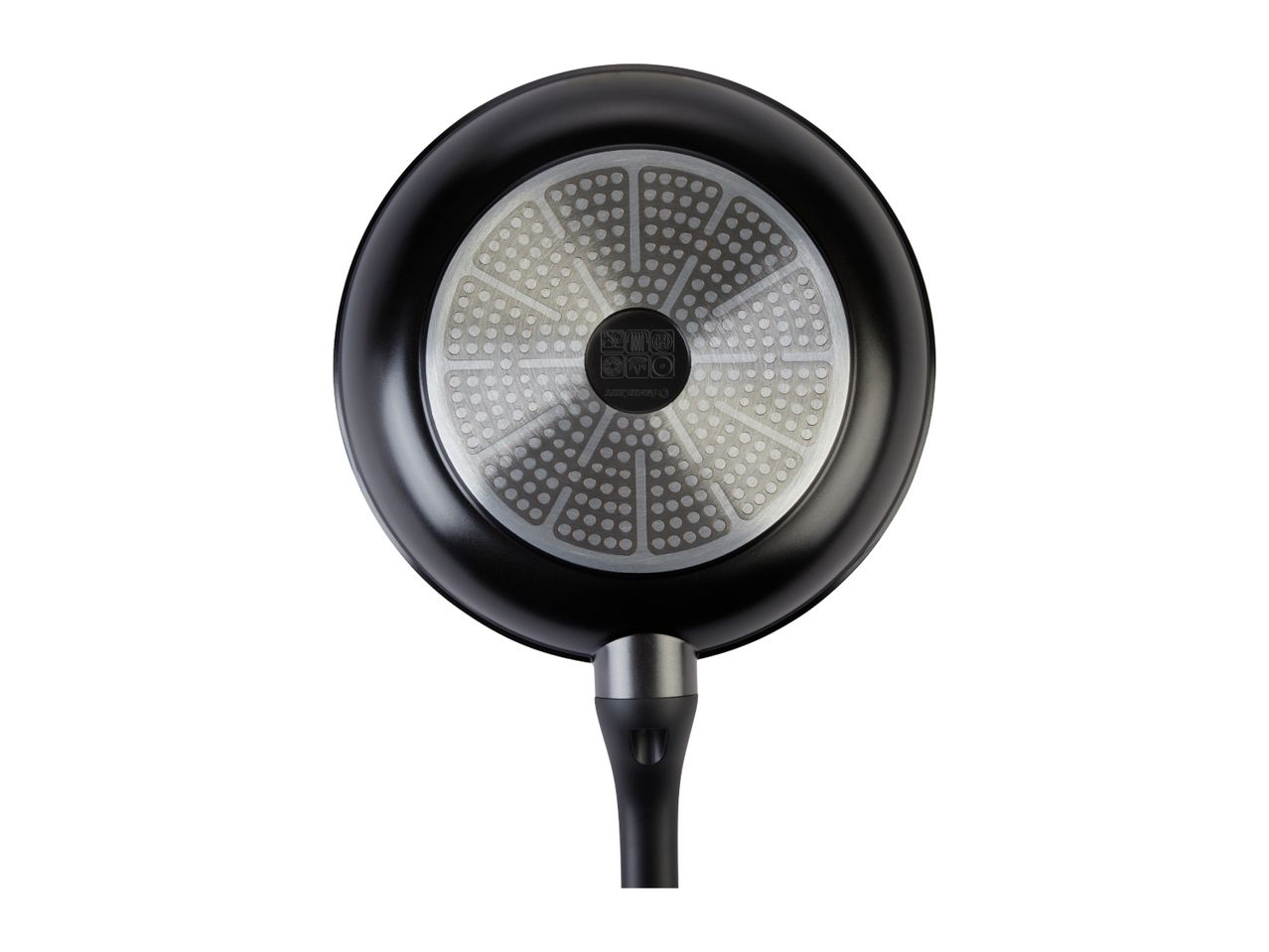 Bottom view of a black frying pan with a textured silver base and a black handle.