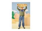 Boy in a green dinosaur sweatshirt and blue jeans holding a treasure map.