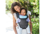 Mother and baby in a baby carrier outdoors.