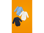 Three lupilu® baby long-sleeve bodysuits in blue, white, and navy on an orange background.