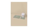 Two green striped bath mats on a beige floor in front of a white toilet.