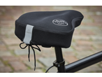 Black bicycle saddle cover with 'Memory Foam' text and reflective strip, on a bike.