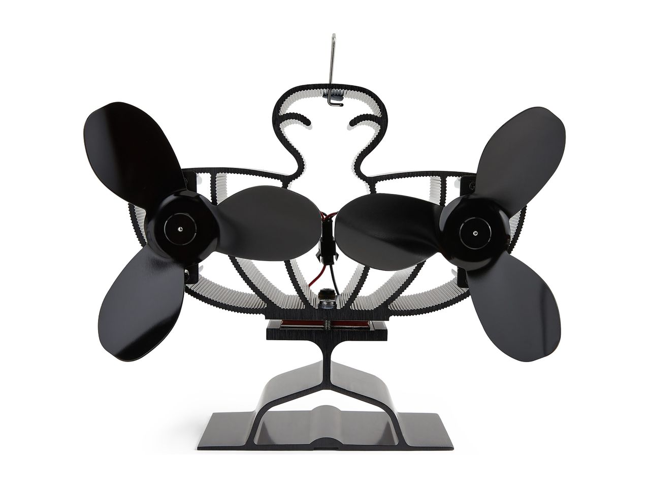 Black twin-fan stove fan with a decorative, wavy frame and a sturdy base.