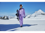 CRIVIT woman in purple ski suit with snowboard on a snowy mountain.
