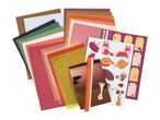 A collection of autumn-themed craft supplies including paper, stickers, and embellishments.