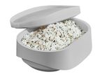 A gray microwave rice cooker with its lid slightly ajar, revealing cooked white and wild rice.