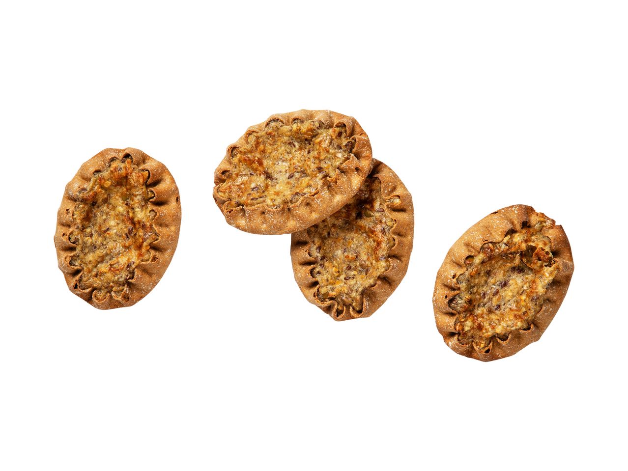 Neljä riisipiirakkaa, joissa on siemeniä.