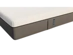 Close-up of an Emma mattress, showcasing its textured top and gray fabric sides.