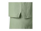 Close-up of a light green textured fabric, possibly a top and skirt set.