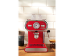 SILVERCREST® Espresso Machine in red on a wooden counter with cups and coffee beans.
