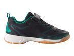 Sports shoes, black sneakers with dark green accents.