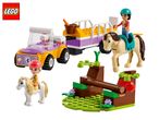LEGO Friends horse trailer with two minifigures, two horses, and an obstacle course.