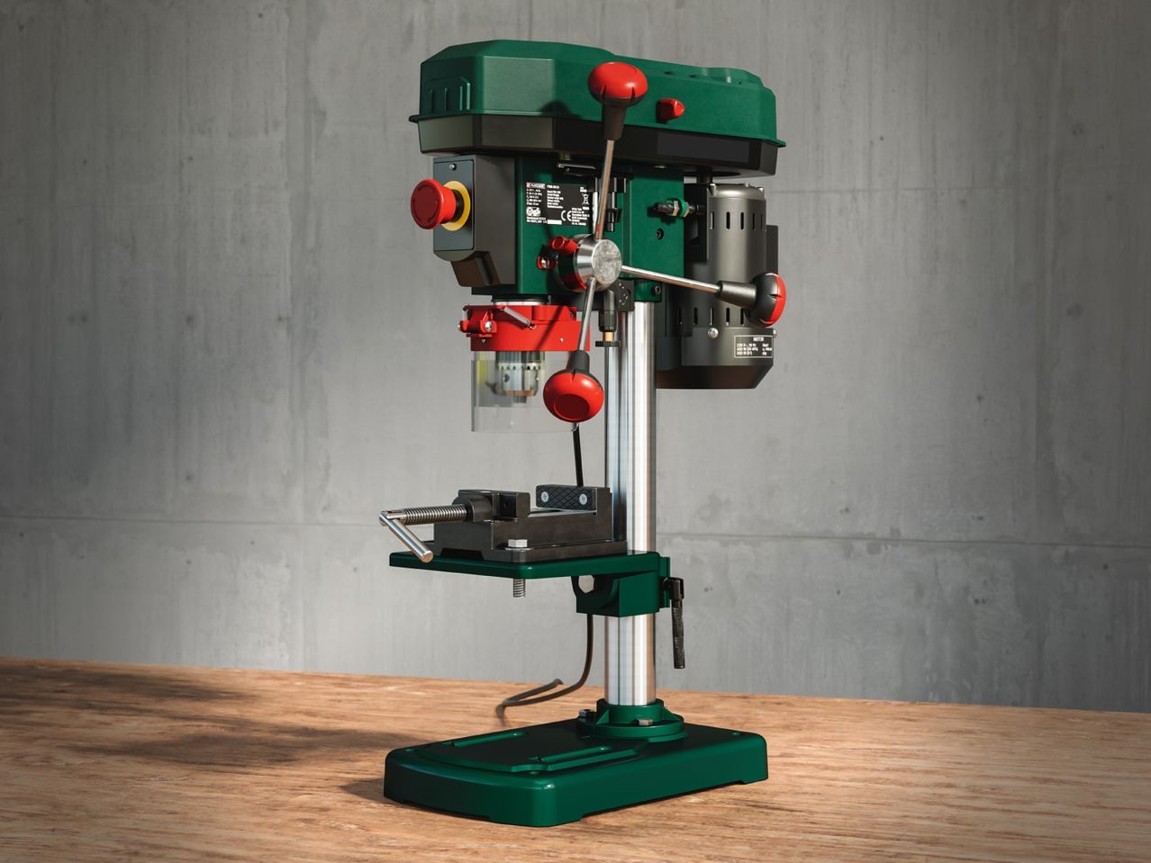 A green benchtop drill press with a vise, ideal for DIY projects.