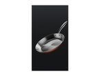 A copper-colored frying pan with a stainless steel interior and handle against a dark background.