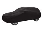 Black car cover protecting a vehicle, showing the wheels.