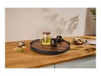 Wooden serving tray with a glass teapot, two black cups, sugar cubes, and cookies.
