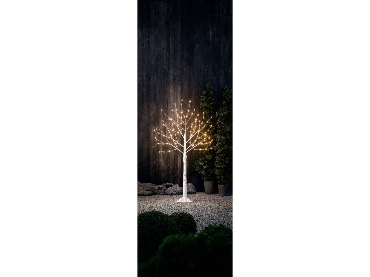 LIVARNO home LED Light Tree with warm white lights in a garden setting at night