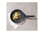 Overhead view of a black speckled frying pan with roasted potatoes and vegetables.