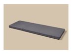 A dark grey foldable mattress on a light beige background.