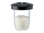 Clear glass container with a black lid, filled with white powdered food.