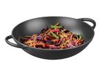 Cast iron wok with stir-fried vegetables including cabbage, carrots, and green beans.