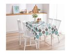 A kitchen dining area with a white table and chairs, featuring a polka dot tablecloth.