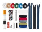 A comprehensive sewing kit with threads, zippers, needles, and measuring tape on a white background.