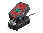 A red and black cordless tool battery is charging on a black charger, with a green light indicating charging status.