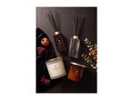 Elegant home fragrance set featuring reed diffusers and scented candles on a dark background.
