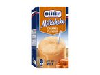Caramel milkshake mix box with a glass of milkshake and caramel candies, American style.