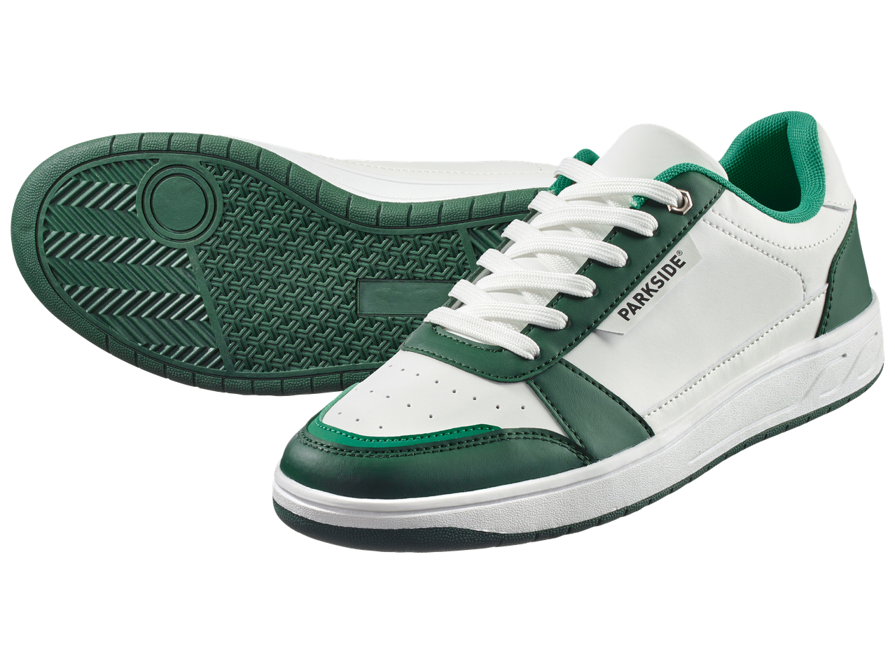 Бели и зелени спортни обувки с връзки, едната обърната, показваща подметката.