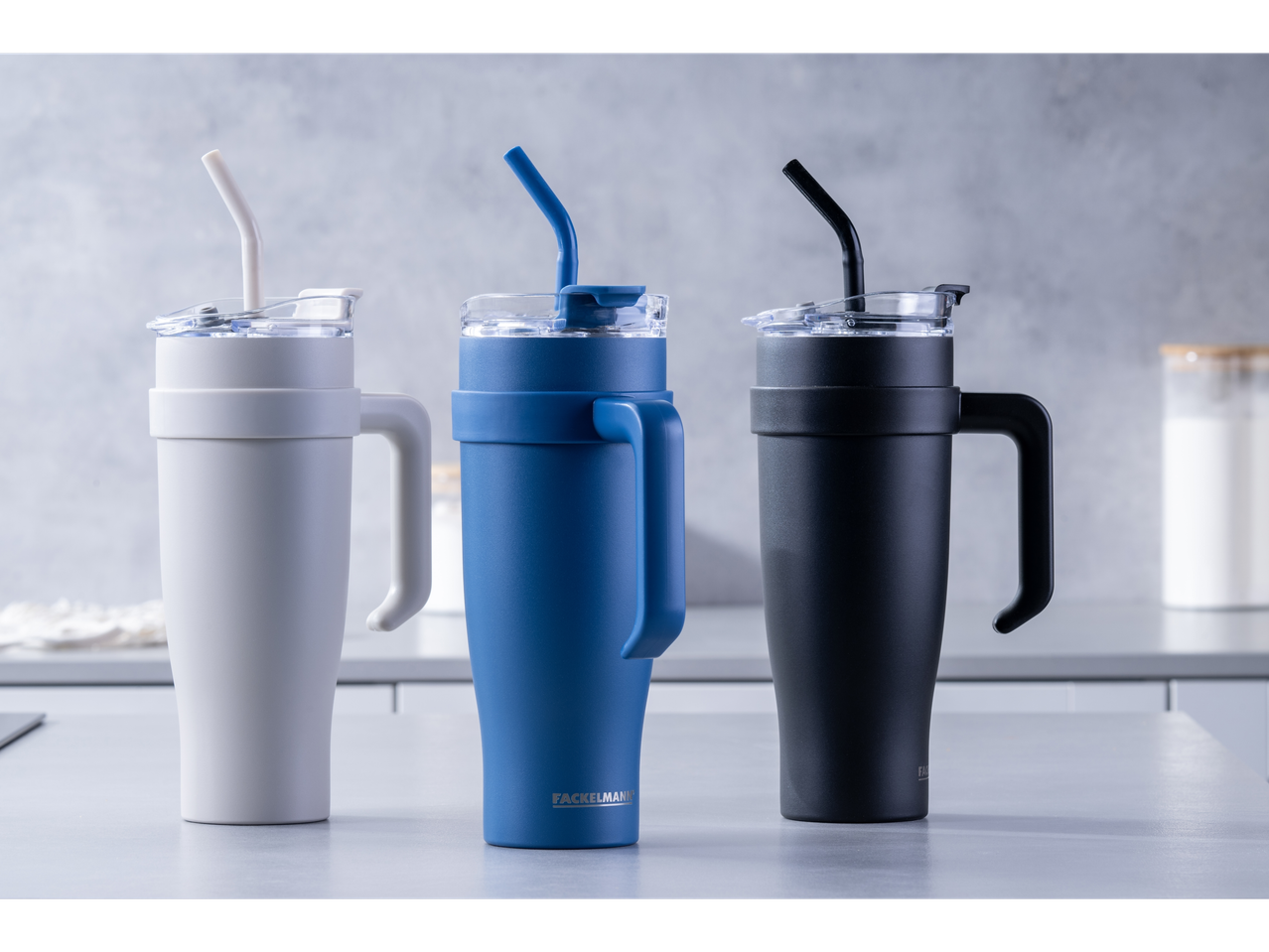 Facelmann travel mugs with lids and straws, in three colors.