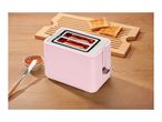 Pink toaster with two slices of toast, jam, and a butter knife on a wooden table.