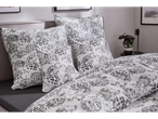 LIVARNO set posteljine od mikrovlakana s crno-bijelim cvjetnim uzorkom na krevetu.