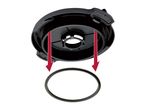 Black plastic component with two red arrows pointing to a black O-ring.